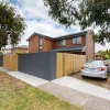 A Melbourne home with a maintained painted exterior sits in an ordinary suburban street.