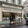 A Melbourne retail storefront in everyday use shows the painted facade and street activity around it.