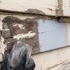 A weathered timber wall shows scraping, filling and priming before exterior painting on a Melbourne home.