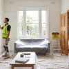 Two painters inspect a Melbourne home’s walls and trim during the final painting and finishing check.