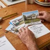 A contractor reviews a homeowner’s property photos and job notes before assessing a painting project.