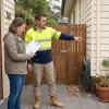 A homeowner and painting contractor review which exterior surfaces, including a garage door, are included in the painting scope.