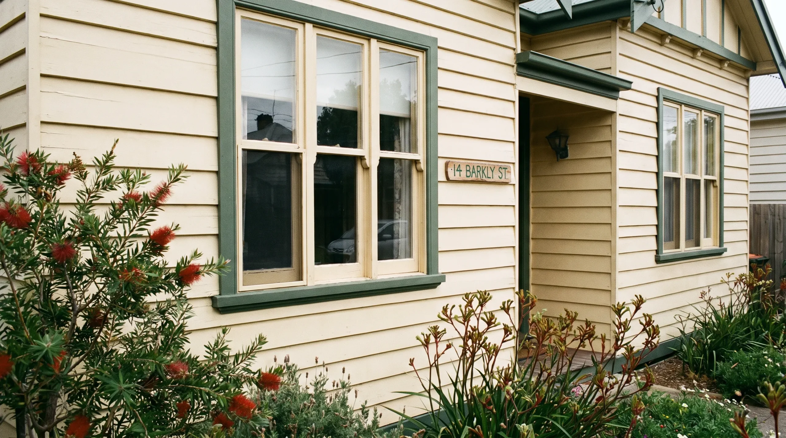 A Melbourne weatherboard home's exterior boards and timber window frames show an even finish, with neat paint edges along the trim.