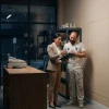 A shop manager and painting contractor discuss the work area and access before agreeing on a commercial painting quote.